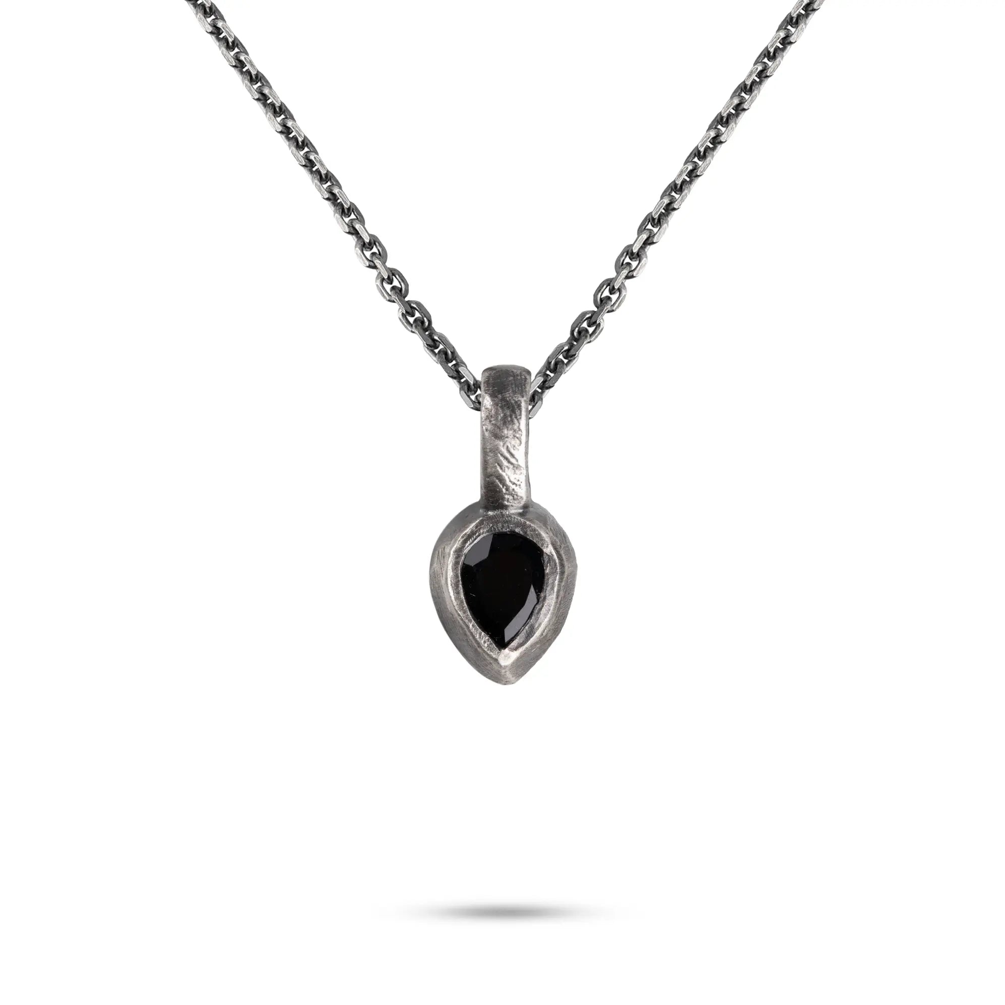 Black Onyx Necklace hanging from a sterling silver chain featuring a hand-carved pendant.