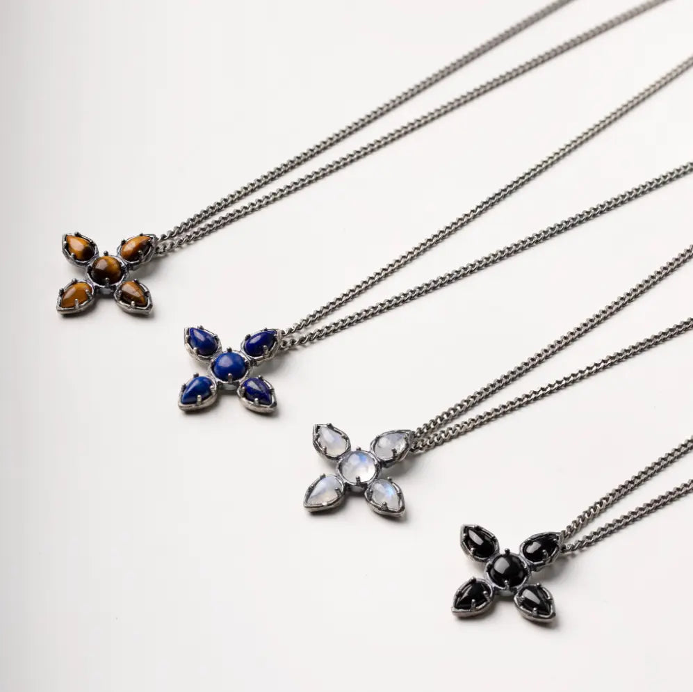 Various large cross necklaces with tiger eye and other gemstones on oxidized silver chains, showcasing a stylish and unique gift option.