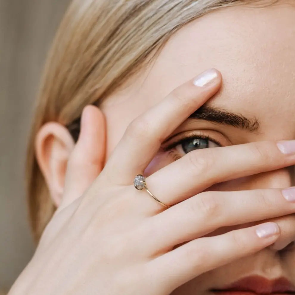 Woman wearing a Raw Diamond Ring in 14K gray gold, showcasing modern minimalist style with natural gemstone jewelry.