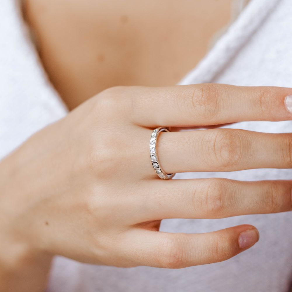14K gold Diamond Wedding Band on woman's hand, featuring 9 brilliant cut diamonds, elegant and modern design.