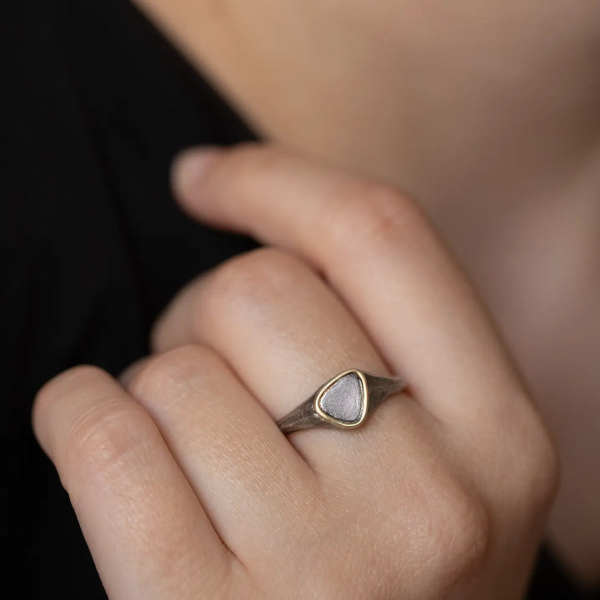 Men's Small Signet Ring in Silver and 14K Gold worn by a model, showcasing its unique design and craftsmanship.