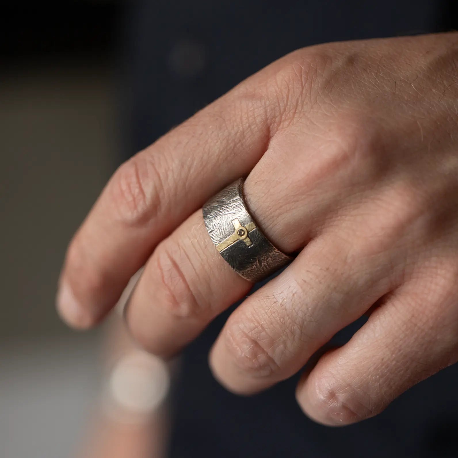 Men's Diamond Cross Ring on a hand showcasing a unique design in 14K gold and oxidized 925 silver.