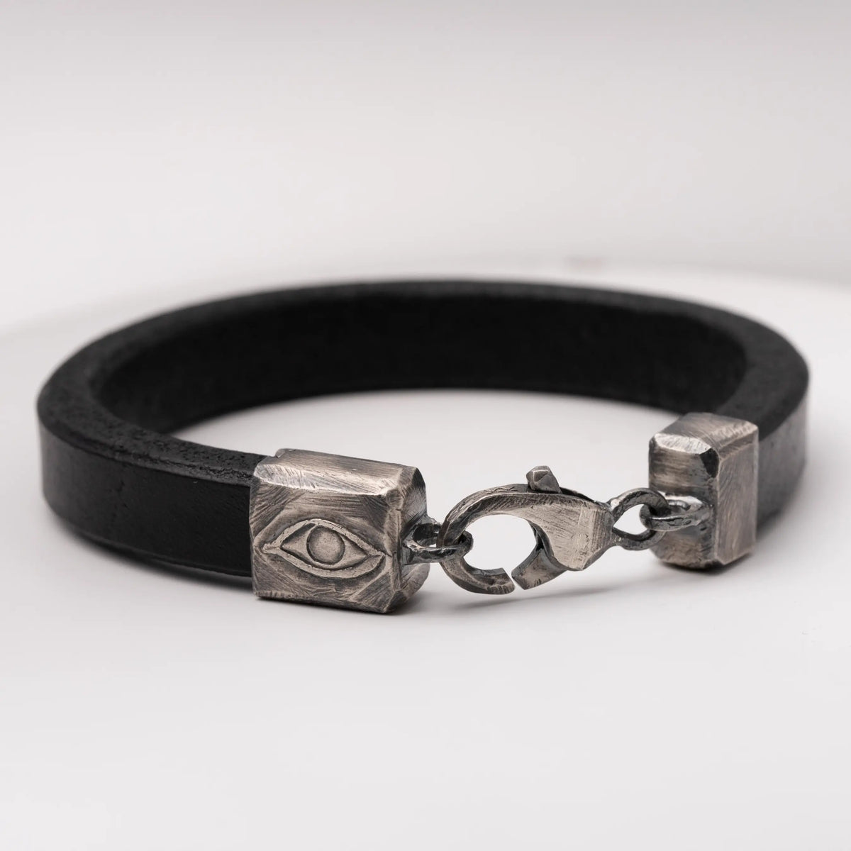 Close-up of Men's Leather Bracelet with Oxidized Silver Evil Eye Clasp