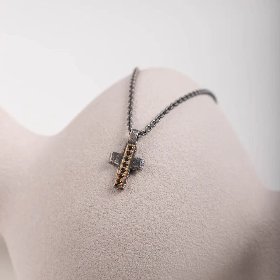 Cross Necklace Black Diamonds Silver & Gold displayed on a bust with a sleek design and black oxidized silver finish.