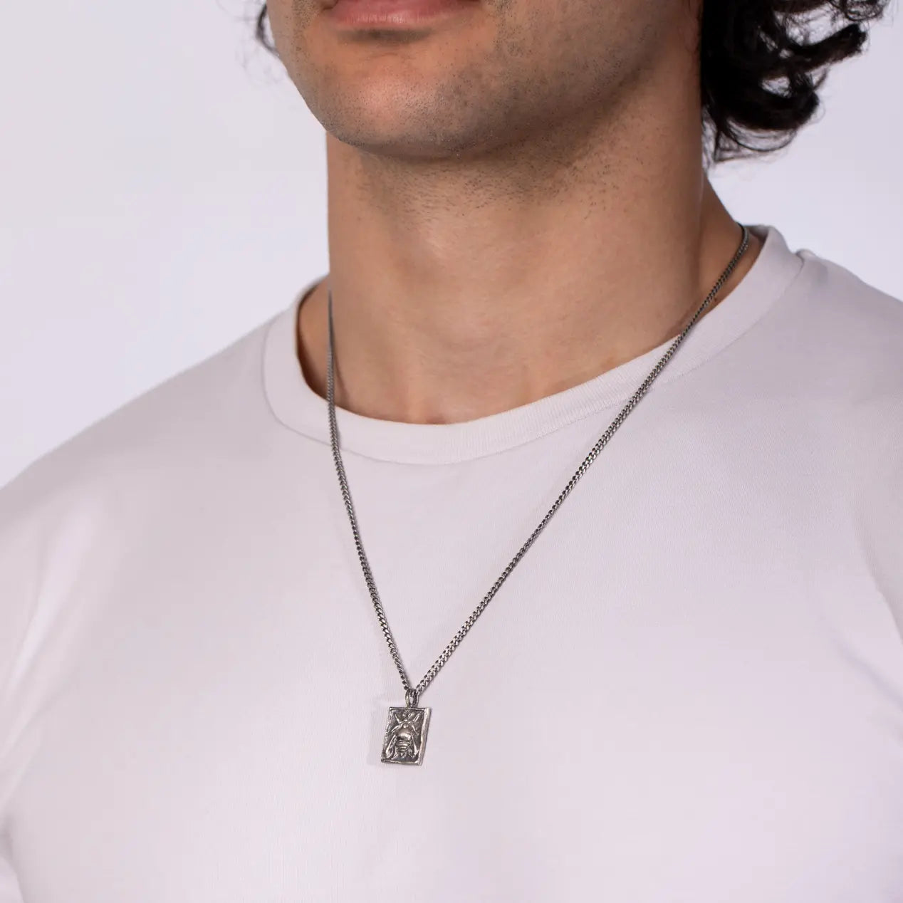 Man wearing Ancient Greek Bee Necklace Oxidized Silver 925 on a white shirt