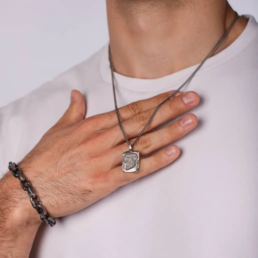 Ancient Greek Column Necklace Oxidized Silver 925 worn on a man's neck, showcasing the detailed design on a thin chain.