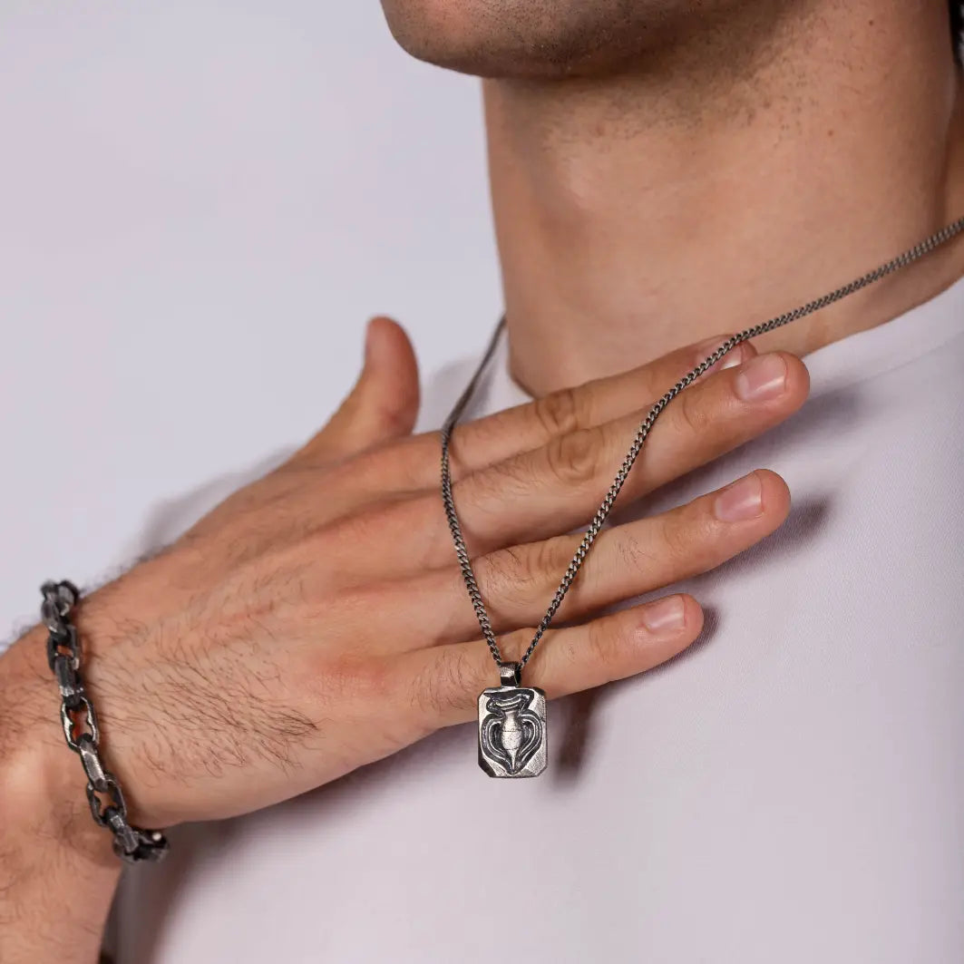 Man wearing Ancient Greek Amphora Necklace Oxidized Silver 925 on a chain showing historical craftsmanship and elegance.