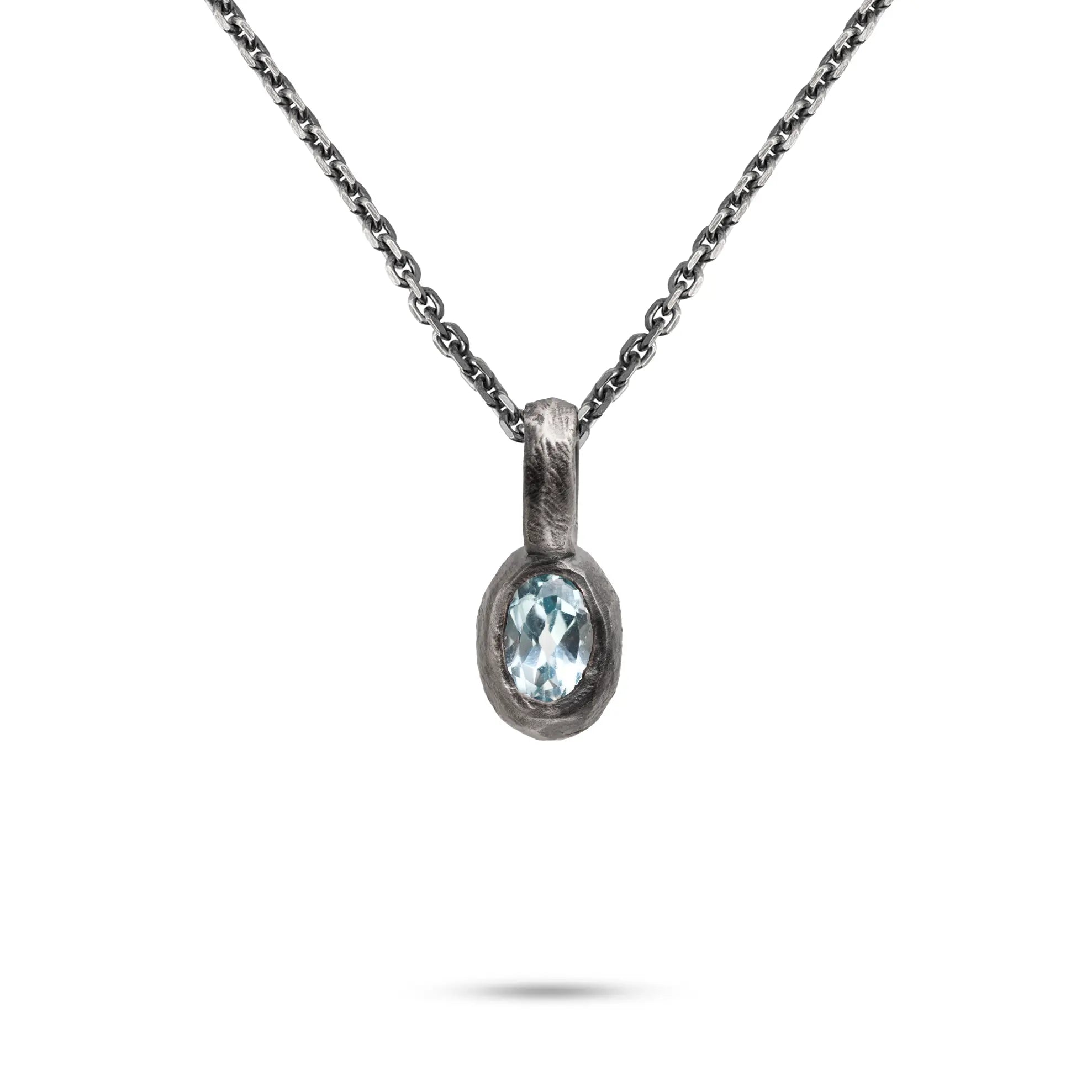 Blue Topaz Necklace with Sterling Silver 925 chain showcasing a hand-carved pendant featuring a vibrant blue gemstone.